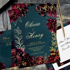 wedding stationery with burgundy flowers and gold foil on green paper, next to a pen