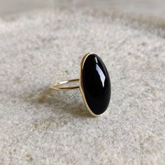 ITEM DESCRIPTION: >>The ring is made from Solid 14K Yellow Gold. >>Gemstone used is absolutely natural and ethically sourced. >>Natural Black Onyx in Oblong Oval Shape in bezel setting is studded on it with utmost precision. Gem: Black Onyx Gem size & shape: 20×10 mm and Oblong Oval Gem weight: 8.44 Carats Gold purity: 14K (58.33% approx.) Gold weight: 1.14 grams Gross weight of ring: 2.83 grams The Gold purity is guaranteed and it comes with authentic 14K gold hallmark. Since these Rings are ha Black Oval Jewelry With Bezel Setting, Black Oval 14k Gold Rings, Fine Jewelry Onyx Oval Ring, Fine Jewelry Oval Onyx Ring, Black Cabochon Ring In 14k Gold, Black Cabochon 14k Gold Rings, Black 14k Gold Cabochon Ring, 14k Gold Black Cabochon Rings, Oval Cabochon Onyx Ring