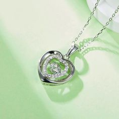 An eye-catching round moissanite dances with ease at the center of this appealing women's necklace, expressing your unstoppable love. Additional round gem set in sterling silver frame the center. Features Moissanite was originally found in meteorites(Chemical name: Silicon Carbide). It was first discovered in 1893, while a scientist was examining meteor samples from a crater in Arizona. After many years, the experts has been recreated moissanite in the laboratory, that make the gemstone with fri Double Heart Necklace, Women's Necklace, Silicon Carbide, Moissanite Necklace, Moissanite Jewelry, Round Moissanite, Double Heart, Timeless Jewelry, Stone Cuts