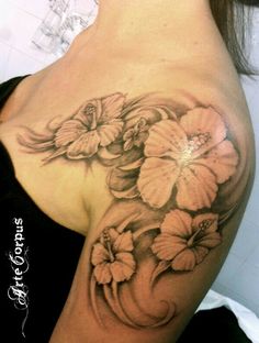 a woman's shoulder with flowers on it