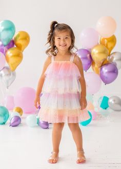 This enchanting Mabel and Honey empire waist dress is sleeveless with delicate tie-up straps. It features multiple layers of pastel pink tulle embellished with sparkling golden dots, creating a magical effect. The lightweight fabric ensures a flowy, fairy-tale silhouette, perfect for any special occasion or princess party. Fabric Care 100% POLYESTER Machine Wash Cold | Line Dry Do Not Bleach Rainbow Tulle Dress, Dress With Sparkles, Cotton Gauze Dress, Girls Easter Dresses, Girl Rainbow, Gauze Dress, Empire Waist Dress, Pink Tulle, Easter Dress