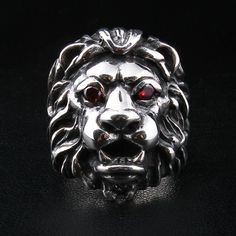 "RED GARNET EYES STERLING SILVER LION RING ~BRAND NEW made of 100% sterling silver; the 925 hallmark stamp is inside the band; comes with two red CZ stones; the ring's face measurements: 28 mm x 32 mm (1.10\" x 1.25\"); weight: 37 grams; this is a hand-made product. The King of the Jungles is an enduring symbol of masculinity, virility, and brawn. We don't know a single man who would not want to be like a lion. If you, too, want to have a lion's courage and nobility, this Red Garnet Eyes Sterling Silver Lion Men's Ring will fit the bill. They say that lion talismans are able to turn even the timidest person into a leader and Alfa male. Why don't you test whether it is true by pitting this hell of a ring on your finger? Even if it doesn't have any magical properties, you will surely like it A Single Man, Wallet Chains, Majestic Lion, The Ring Face, Lion Ring, Face Measurements, Single Man, Like A Lion, Biker Rings