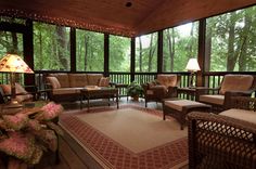 a covered porch with wicker furniture and lamps