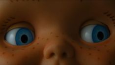 an image of a doll's face with blue eyes and nose markings on it