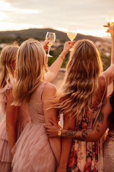 three women are holding wine glasses in their hands