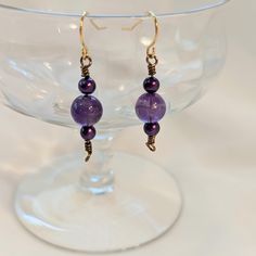 Purple drop earrings, featuring glass beads flanked by small purple pearls. Wire wrapped with bronze-colored wire. Simple but elegant design. Can be worn casual or dressy. 1 inch drop Elegant Hypoallergenic Beaded Earrings With Czech Glass, Elegant Wire Wrapped Crystal Earrings With Round Beads, Elegant Purple Beaded Earrings With Ear Wire, Elegant Wire Wrapped Round Crystal Earrings, Adjustable Purple Wire Wrapped Beaded Earrings, Purple Wire Wrapped Beaded Earrings For Gift, Elegant Lavender Beaded Drop Earrings, Purple Wire Wrapped Drop Beaded Earrings, Elegant Bronze Beaded Earrings