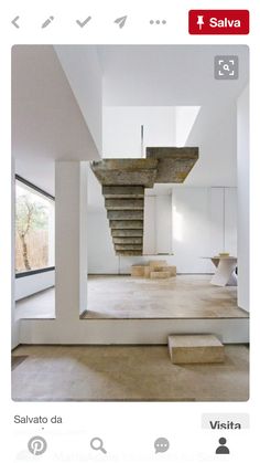 an image of a staircase in the middle of a room with white walls and floors