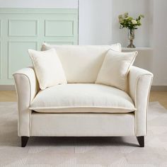 a white couch with two pillows on top of it