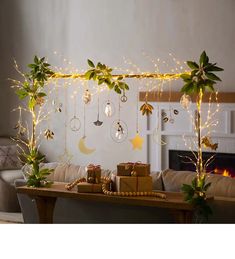 a living room filled with furniture and christmas decorations on top of a wooden table next to a fire place