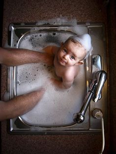 a man is taking a bath in the sink