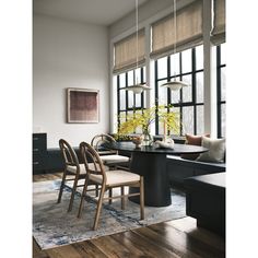 a dining room table with chairs and flowers in vases on the table next to it