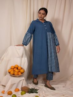 Blue button down kurta and pants(Set of 2) 100% Cotton Fabric Hand-dyed / Hand block printed striped cotton fabric A-line, wide hem, front buttons Check panel on one side Balloon sleeve detail Checkered pants, elasticated waist, comfortable hip Measurements: Kurta - S - Shoulder-14.5”, Bust-36" M - Shoulder-15”, Bust-38” L - Shoulder-15”, Bust-40” XL - Shoulder-15.5”, Bust-42” XXL - Shoulder-16”, Bust-44” Length - 46" Pants - S- waist 28"(elasticated back), Hip- 40" M- waist 30"(elasticated back Womens Kurta, Kurta And Pants, Cotton Kurta Set, Checkered Pants, Checkered Jacket, Suspender Pants, Cotton Crop Top, Gathered Dress, Cotton Shirt Dress