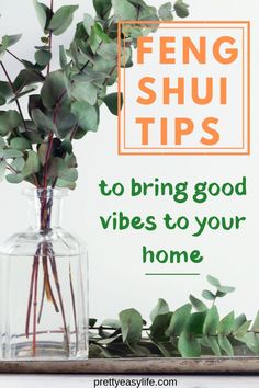 a vase filled with green leaves on top of a wooden table next to a plant