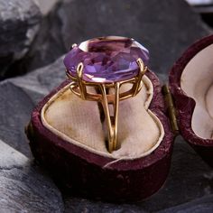 This classic cocktail ring is centered with an elegant oval cut amethyst. The chunky gem is held aloft by a split shoulders setting with a light patina. The ring is crafted in 14k yellow gold is currently a size 5.25. Cocktail Ring Designs, Purple Cocktails, Amethyst Cocktail Ring, Classic Cocktail, Amethyst Cluster, Classic Cocktails, Amethyst Ring, Cluster Ring, Cocktail Ring