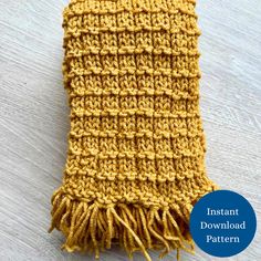 a yellow knitted dishcloth sitting on top of a wooden table