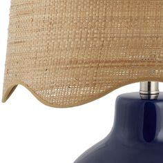 a table lamp with a blue shade on the base and a brown fabric covering over it