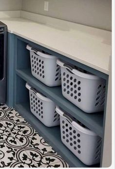 a washer and dryer in a small room with tile flooring on the floor