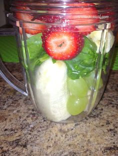 a blender filled with fruit and vegetables on top of a counter