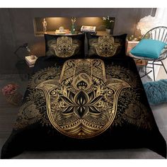 a bed with black and gold comforters in a room