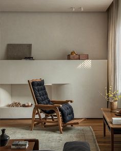 a living room filled with furniture and a fire place next to a wall mounted shelf