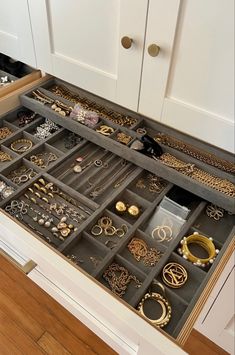 an organized drawer in a kitchen filled with jewelry