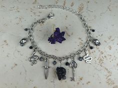 Handmade by Jennifer Nicole. Made with metal, glass beads and labradorite. Hades Jewelry, Hades Aesthetic, Hades And Persephone, Snakes, Charm Bracelets, Labradorite, Glass Beads, Jewelry Bracelets, Charm Bracelet