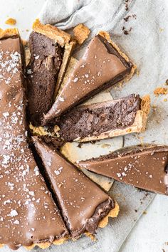 a chocolate tart pie with one slice cut out and the rest on top of it