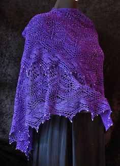 a purple shawl draped over a black dress