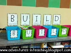 colorful plastic bins with word blocks on them in front of a bulletin board that says build