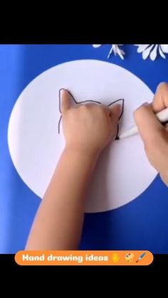 a person drawing on a piece of paper