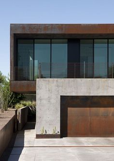 a concrete building with two garages on the side