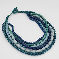 Multiple strands of blue wooden beads are layered together to make up this beautiful statement necklace. Each strand features a different shape and size bead. Hung on a toggle closure, the length of the necklace is made to be shorter to accentuate your neckline. Necklace hangs 18"in length  Made to match UN23E01 BLUE Care Instructions: Remove jewelry when applying perfumes, creams, washing hands, etc. Do not store in direct sunlight. To restore color and shine, apply a drop of oil with a soft cloth Washing Hands, Fashion Capsule Wardrobe, Jewerly Beads, Colorful Necklace, Necklace Colorful, Bold Necklace, Necklace Blue, Lovely Necklace, Colourful Necklace