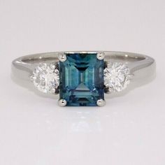 three stone ring with blue and white diamonds