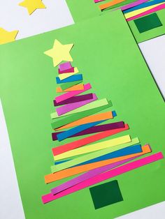 the paper christmas tree is made from strips of colored construction paper and then cut out with scissors