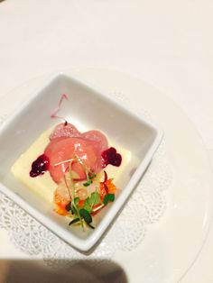 a white plate topped with food on top of a table