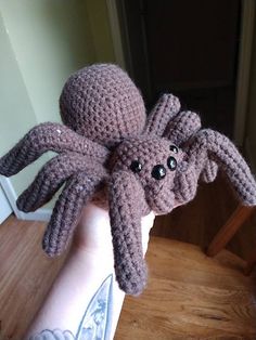 a crocheted octopus made to look like it is holding onto someone's hand