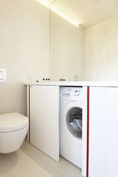 there is a washer and dryer in the bathroom next to each other,