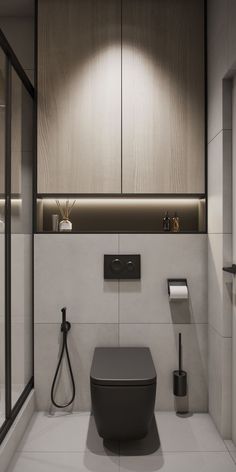 a bathroom with a toilet, sink and shower head in it's center wall