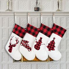 three christmas stockings hanging on a wall with reindeer, snowman and truck designs in red and black