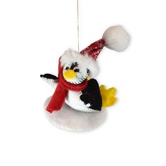 a stuffed penguin ornament hanging from a string