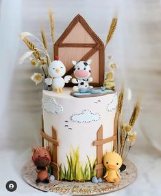 a cake decorated with farm animals on top of it