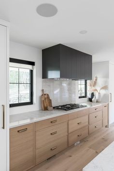 a kitchen with wooden cabinets and white counter tops