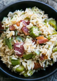 a black bowl filled with rice and vegetables