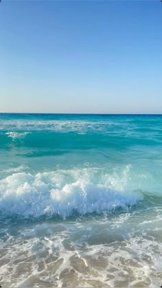 the ocean is blue and green with white waves