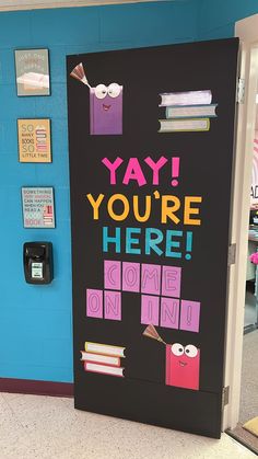 a door decorated to say you're here and some books are on the wall