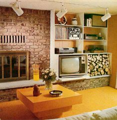 a living room filled with furniture and a fire place in front of a brick wall