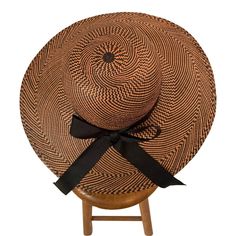 This fabulous wide brimmed picture hat is woven from black and tan straw in six different patterns.  The crown is trimmed with a black on black herringbone pattern ribbon.  The brim perfectly shields your face from the sun while sweeping down to your neckline in the back.  It bears the label of Roslyn in New York City and it is in excellent condition. Measurements;  Height 7.5"  Width 17"  Depth 17" Black Brimmed Woven Panama Hat, Black Brimmed Toquilla Straw Hat, Black Straw Hat With Curved Brim, Black Woven Brimmed Panama Hat, Black Woven Panama Hat With Short Brim, Black Woven Fedora Hat, Black Woven Panama Hat With Flat Brim, Black Woven Flat Brim Panama Hat, Summer Black Handwoven Sun Hat