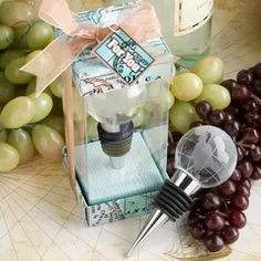 a wine bottle stopper sitting on top of a table next to grapes