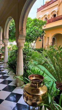 an ornate courtyard with potted plants and greenery