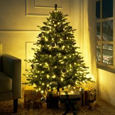 a lit christmas tree in a living room